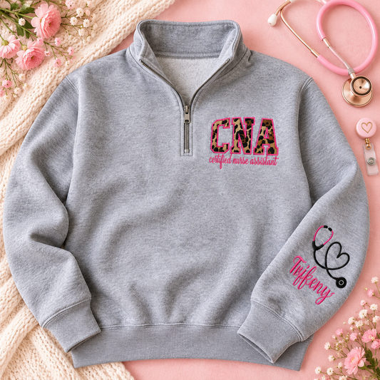 Oxford gray CNA quarter zip flat lay on blush pink background